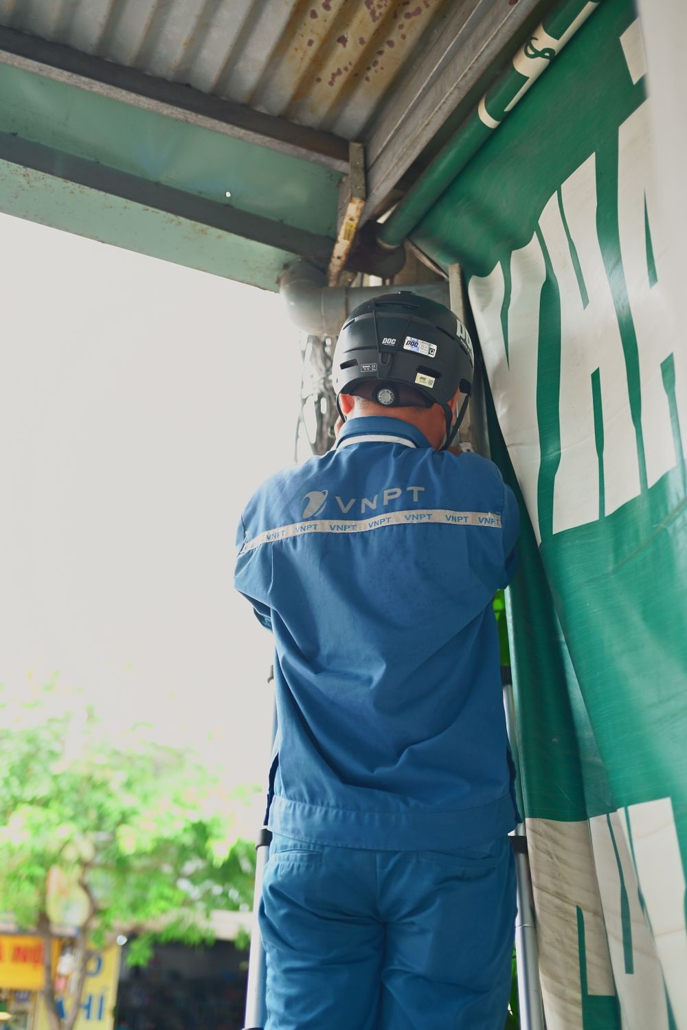 Technician installing equipment outside a building
