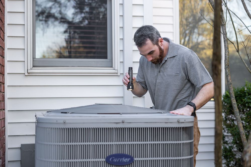 Technician checking an outdoor air conditioning unit