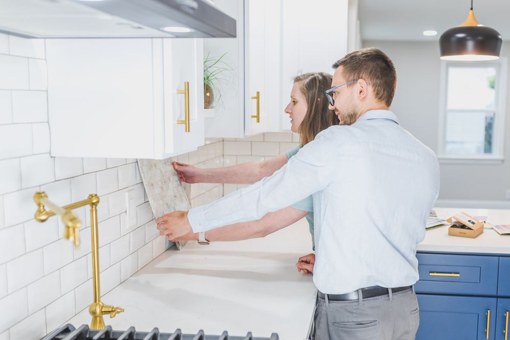 Designer showing a homeowner backsplash tile in her kitchen
