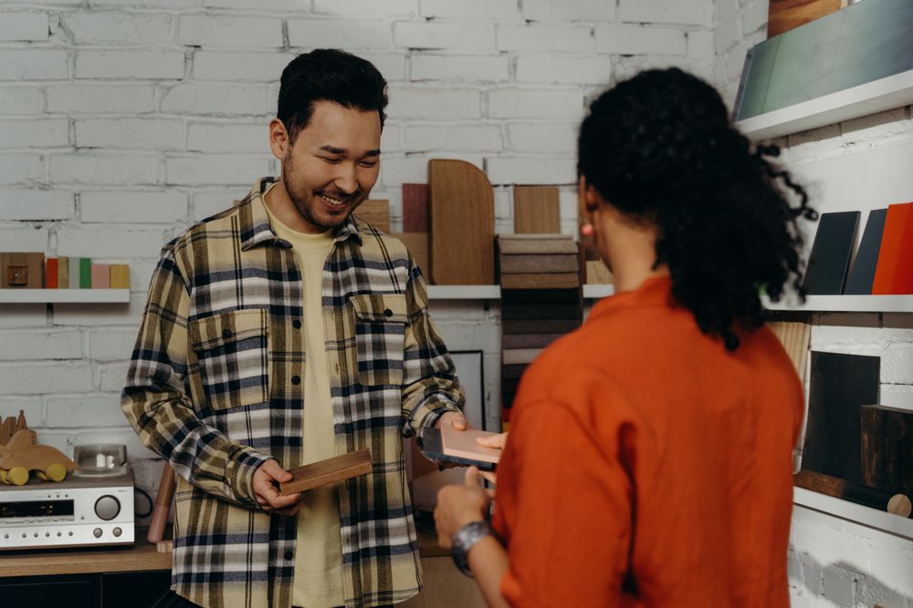 Salesman showing a customer wood samples in a showroom