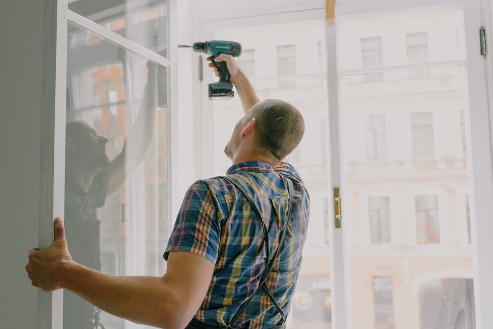 Installer fitting a new window frame